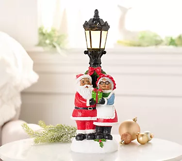 369653-santa-and-mrs-claus-with-illuminated-lamp-post-by-valerie-1.webp